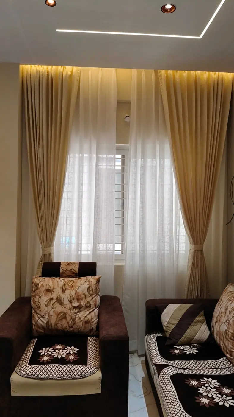 Sheer and drape curtains with tie-backs in a living room