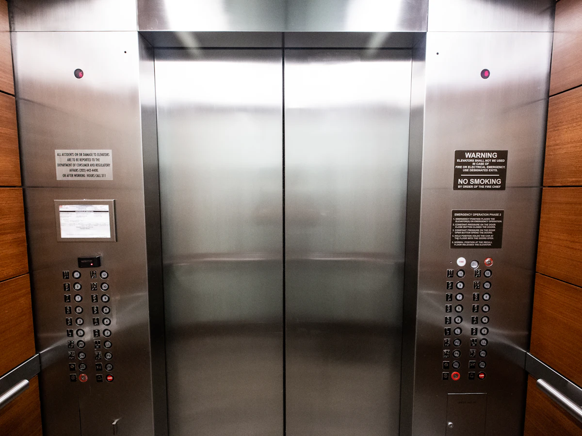 Stainless steel lift doors with call buttons